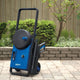 Blue and black pressure washer by Nilfisk Core 150, standing outdoors on a paved surface.
